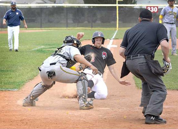 spt deh kcac tourney ottawa v okla wesl bball slide at home