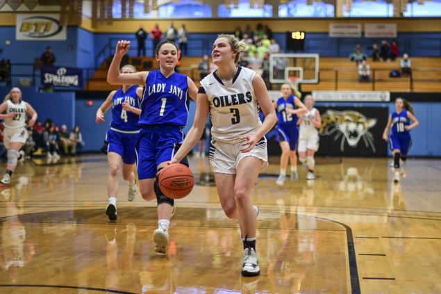 Brynna Hammeke drives in and gets a basket.jpg