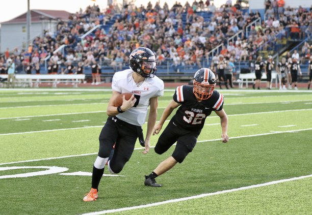 Quarterback Carson Shaver keeps the ball and picks up a first down.jpg
