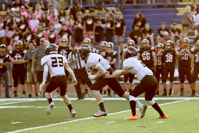 Luke Fischer gets the ball from quarterback Carson Shaver.jpg