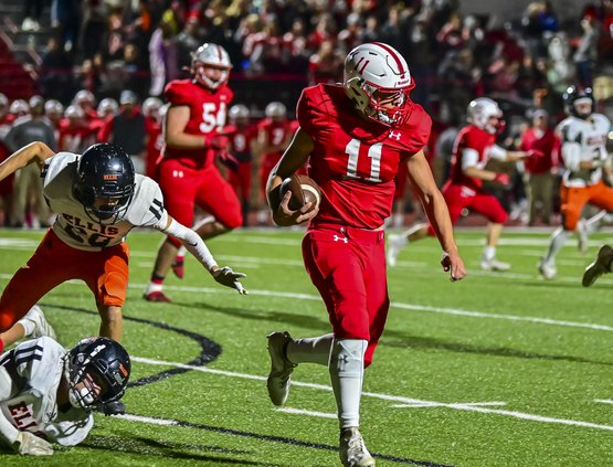 Hoisington's Tony Moore escapes the tackle and rushes through the defensive lineman.jpg