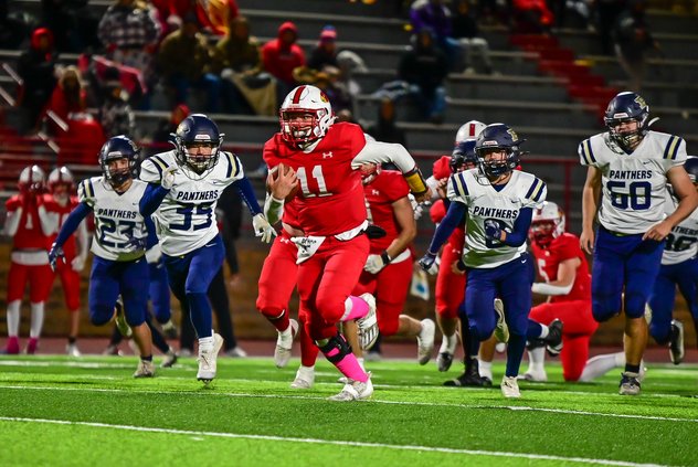 Hoisington's quarterback Tony Moore carries the football and scores a touchdown against Phillipsburg.jpg