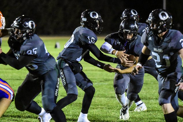 Oiler's Eli Hurley gets the handoff from quarterback Brodie Crites.jpg