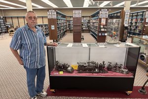Bill Schwartz with display of metal art