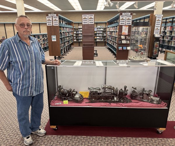 Bill Schwartz with display of metal art