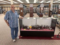 Bill Schwartz with display of metal art
